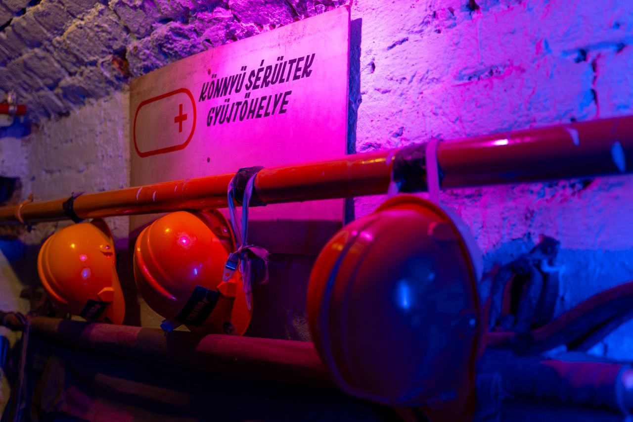 Chernobyl escape room – a row of helmets on the pipes